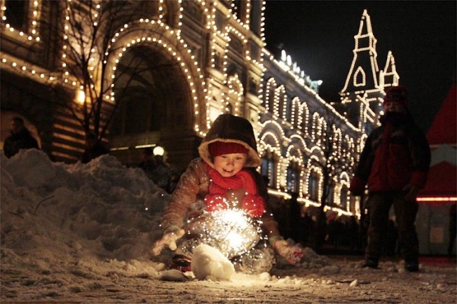 A child plays with sparklers during New Year's celebrations at Red Square in Moscow